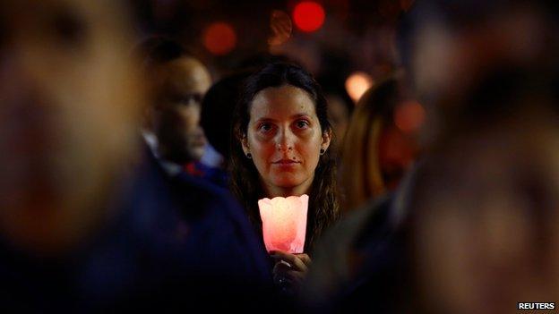 A woman holds candle during a vigil in St Peter's Square, led by Pope Francis to mark the opening of the synod.