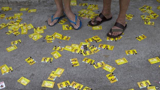 Electoral propaganda litters the street outside a school during general elections in the Rocinha slum in Rio de Janeiro, Brazil, Sunday, Oct. 5, 2014