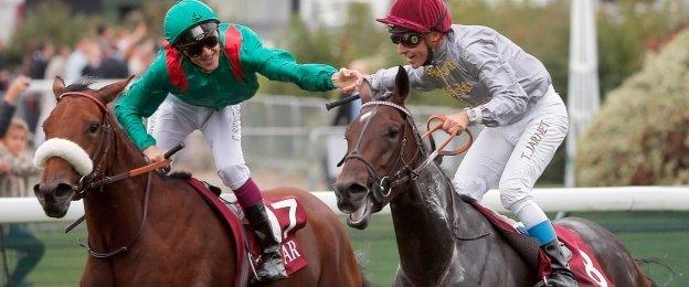 Thierry Jarnet, riding Treve, right, celebrates with Christophe Soumillon, riding Dolniya