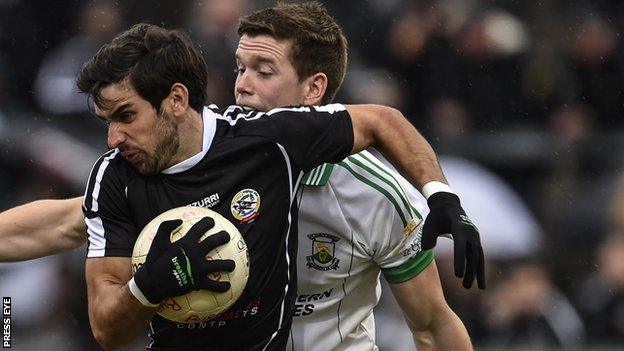 Niall Branagan of Kilcoo in action against Burren's Shay McArdle