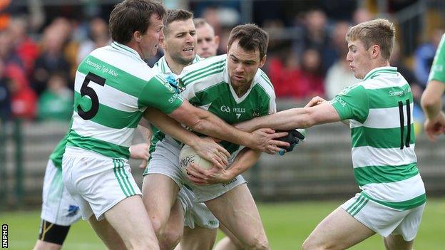 Teemore trio Declan McDonald, Damien Lee and Cian McManus tackle Roslea's Marty Beagan in the Fermanagh final