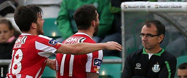 Philip Lowry and Rory Patterson celebrate Derry's equaliser in front of dejected Shamrock Rovers manager Pat Fenlon