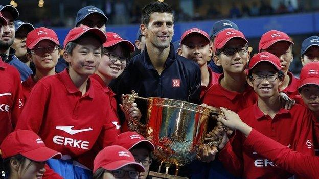 Novak Djokovic celebrates his fifth China Open triumph