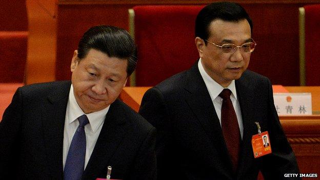 Chinese President Xi Jinping and Chinese Premier Li Keqiang attend the closing session the National People's Congress at the Great Hall of the People in Beijing on March 13, 2014