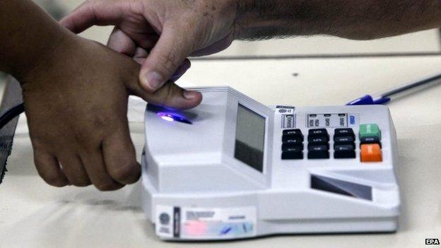 A woman votes at a polling station in a school located in Rio Branco on 5 October 2014