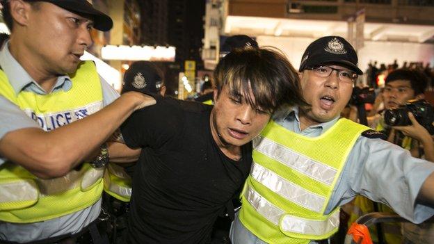 A protester gets arrested by police in the Mongkok neighbourhood as tensions rise between pro-democracy protesters and pro-Beijing on 3 October 2014 in Hong Kong