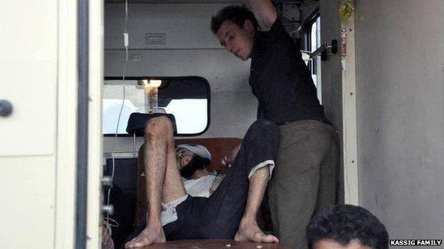 Abdul-Rahman Kassig helping a wounded man near Deir Ezzor, Syria, in August 2013