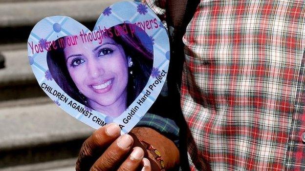 A protester holds up a picture of Anni Dewani outside the Western Cape High Court during the start of the trial of Shrien Dewani, on 6 October 2014 in Cape Town, South Africa