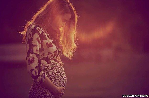 Blake Lively cradling baby bump