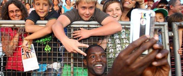 Justin Gatlin takes a selfie with fans after winning at this year's Diamond league meeting in Lausanne, Switzerland