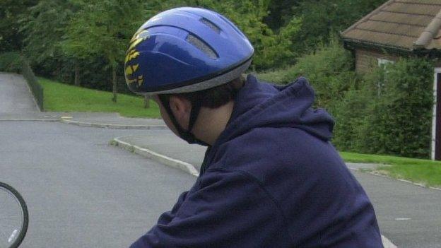 Boy wearing cycle helmet