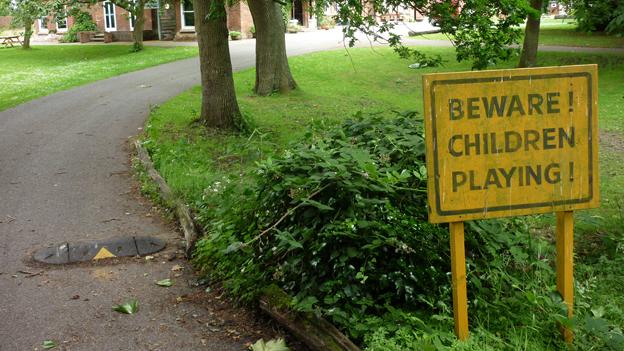 Sign at front of Summerhill reads "Beware children playing!"