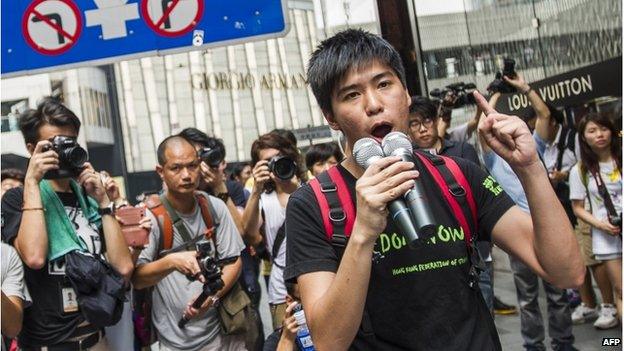 Hong Kong Federation of Students deputy Lester Shum shouts slogans as students protesting for greater democratic rights march in Hong Kong on 24 September 2014