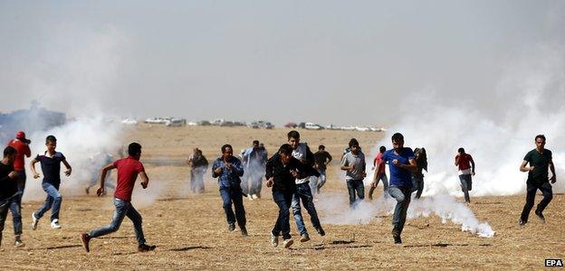 Turkish Gendarmerie use tear gas on Kurdish protestors during a demonstration against Islamic State militants near Sanliurfa, Turkey 7 October 2014