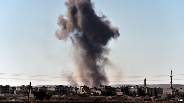 Smoke rises from the southwest of the Syrian town of Ain al-Arab, known as Kobane by the Kurds, following air strikes as seen from the Turkish-Syrian border in the southeastern town of Suruc, Sanliurfa province, on October 7, 2014