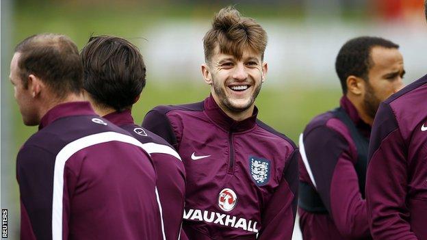 England midfielder Adam Lallana (centre) during training