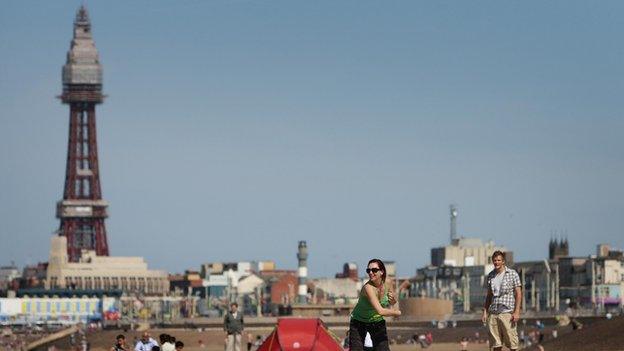 People on the beach with Blackpool Tower in the background