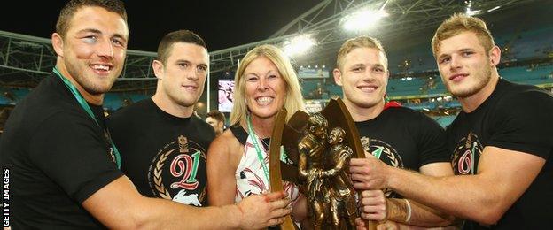 The four Burgess brothers and mother Julie celebrate South Sydney's NRL Grand Final win on Sunday