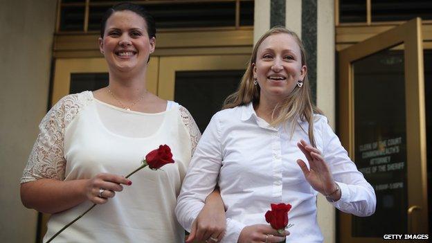 Two women emerge from a Virginia courthouse after getting married on 6 October, 2014.