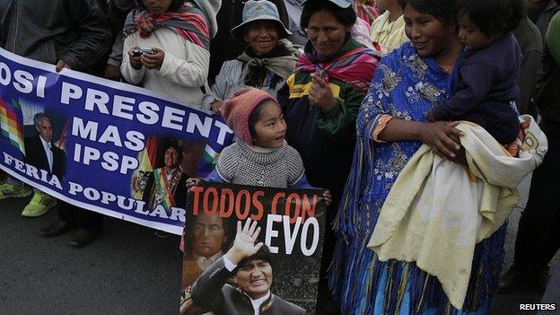 A child holds a poster of Bolivia"s President Evo Morales during a presidential election campaign meeting in La Paz