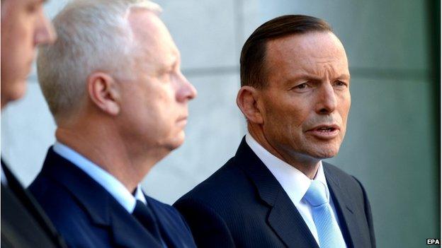 Australian Prime Minister Tony Abbott (R) and Australian Defense Force Chief Air Marshal Mark Binskin (C) during a press conference at Parliament House in Canberra, Australia, 3 October 2014.