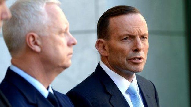 Australian Prime Minister Tony Abbott (R) and Australian Defense Force Chief Air Marshal Mark Binskin (C) during a press conference at Parliament House in Canberra, Australia, 3 October 2014.