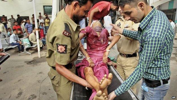 An Indian civilian, injured in reported firing from the Pakistani side of the border in Samba, arrives for treatment at the Government Medical College hospital in Jammu, India, Wednesday, Oct. 8, 2014.