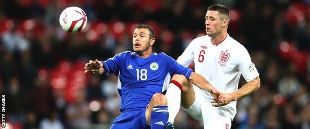 San Marino captain Andy Selva competes for the ball with England defender Gary Cahill during their World Cup qualifier at Wembley in 2012