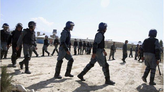 Afghan police officers take positions before the execution of six men sentenced to death at a jail in Kabul, Afghanistan, Wednesday, Oct. 8, 2014.