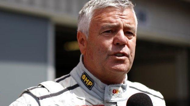 Former F1 driver Derek Warwick speaks to the media