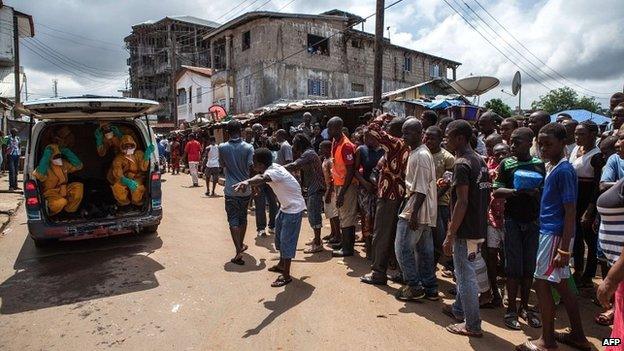 Volunteers arrive to pick up bodies of Ebola victims in Freetown, Sierra Leone - 8 October 2014