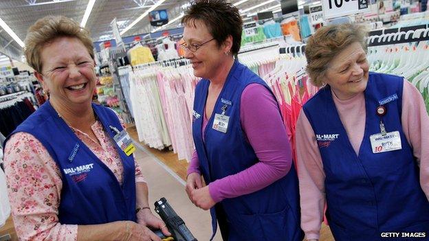 Three Wal-Mart employees stand in the clothing department of an Ohio store.