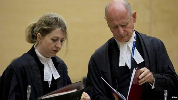 Uhuru Kenyatta's defence lawyers, Steven Kay and Gillian Higgins, look into legal documents at the International Criminal Court in The Netherlands on 8 October 2014