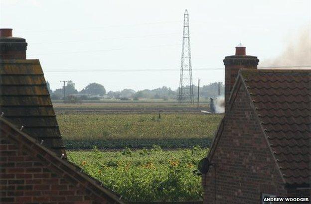 Crash site seen behind houses