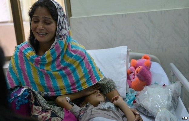 Iram Shahzadi sits with her son in a Pakistani hospital