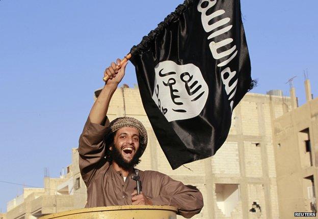 Islaimist fighter on parade in the Syrian province of Raqqa, 30 June 2014