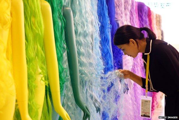 A woman looking at wigs in Henan