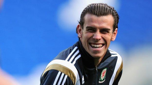 Gareth Bale shares a joke during training with Wales