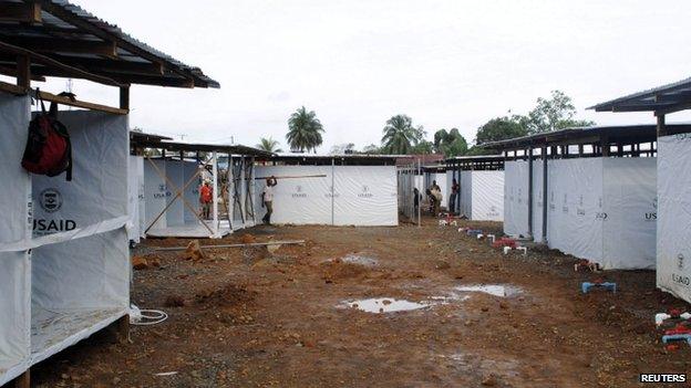 Workers put the finishing touches to an Ebola virus treatment centre in Monrovia, Liberia. Photo: 9 October 2014