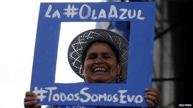 Coca farmer Leonilda Zurita of the Movement toward Socialism holds a picture frame during the closing ceremony of the party's presidential election campaign in El Alto on 8 October, 2014.