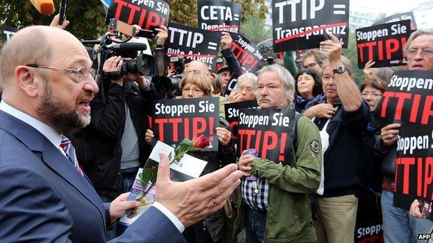 President of the European Parliament Martin Schulz (left) speaks with anti-TTIP protesters in Berlin