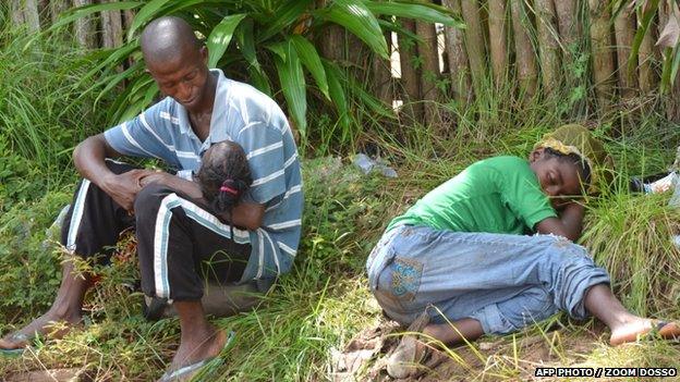 A family sick from Ebola wait for treatment in Monrovia