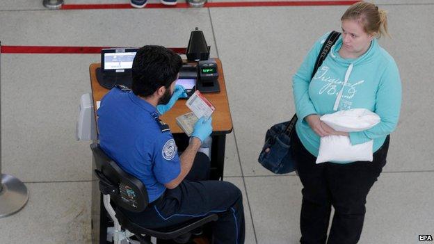 A passenger at Transportation Security Administration checkpoint at John F. Kennedy International Airport, Queens, New York