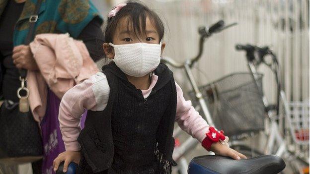 A girl wears a face mask on October 8, 2014 in Beijing