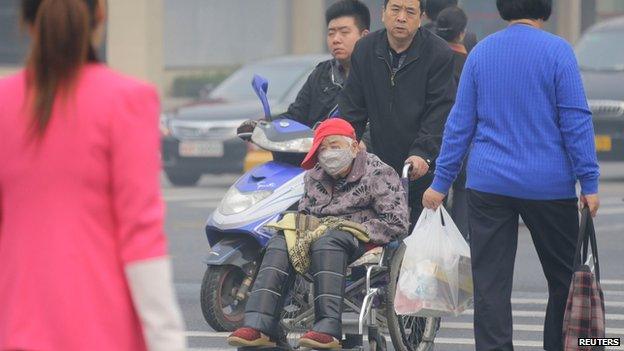 Man in a wheelchair on a Beijing street (10 Oct)