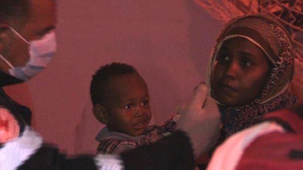 A mother and child who have just arrived in Sicily