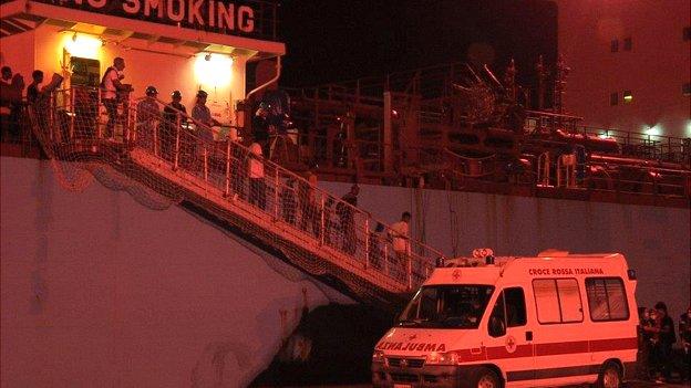 People getting off a boat in Sicily