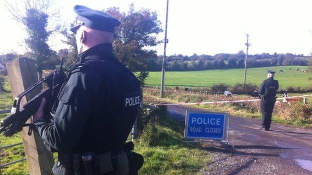 Police guard the outer cordon of the security operation