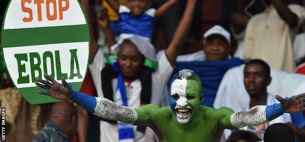 A Sierra Leone football fan with an anti-Ebola placard