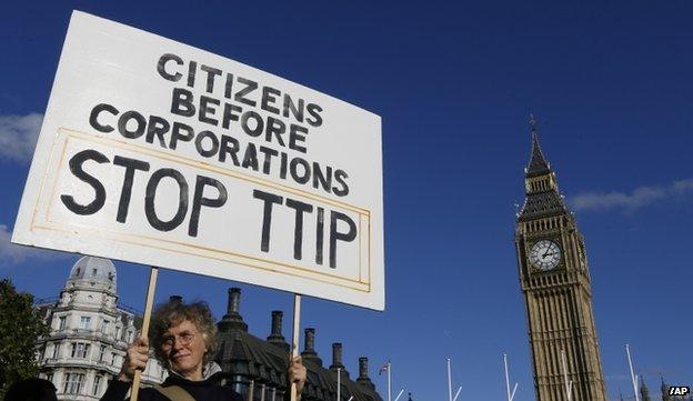 A demonstrator holds a banner in Parliament Square in London on 11 October 2014